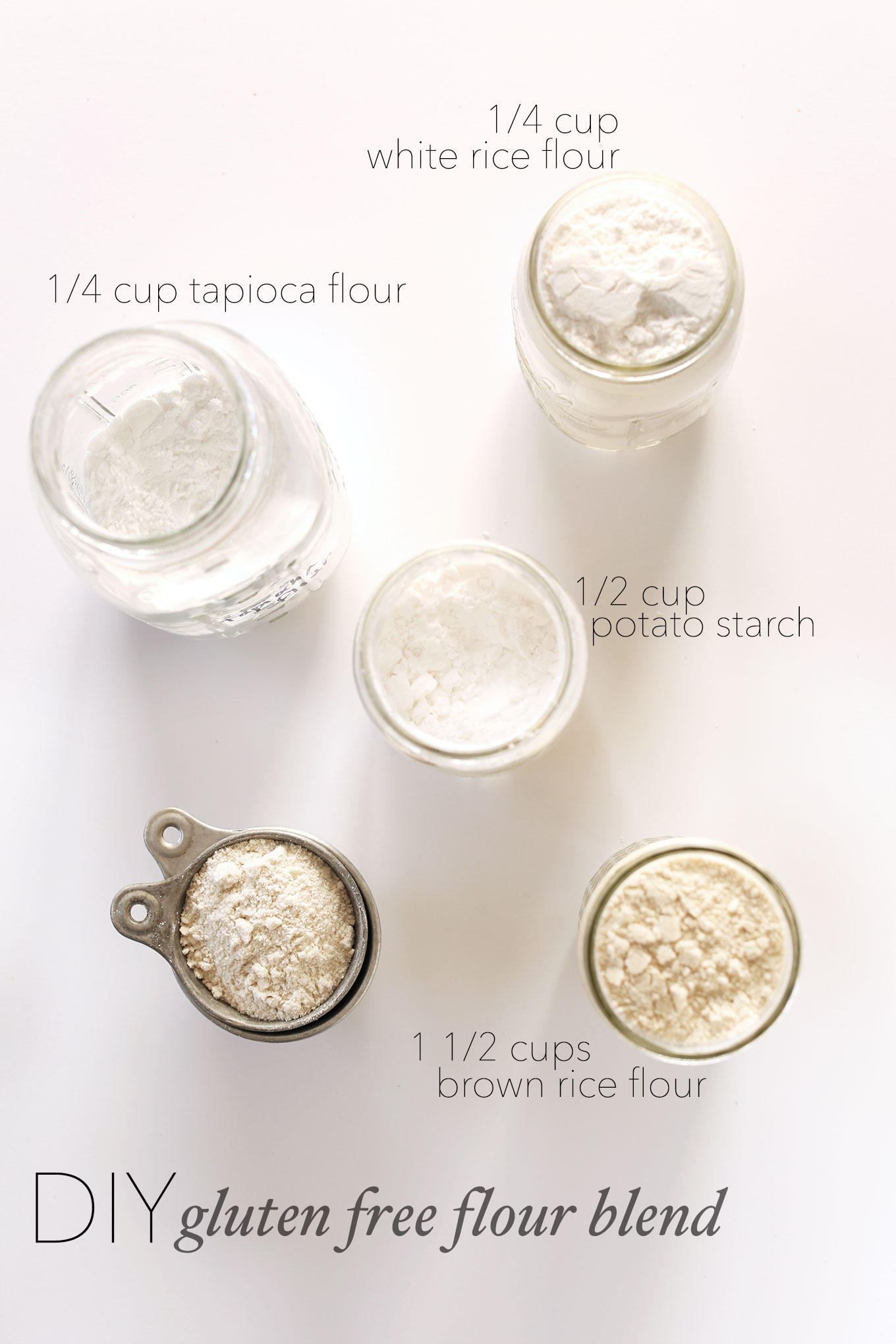 Jars and measuring cups of ingredients for making our DIY Gluten-Free Flour Blend recipe