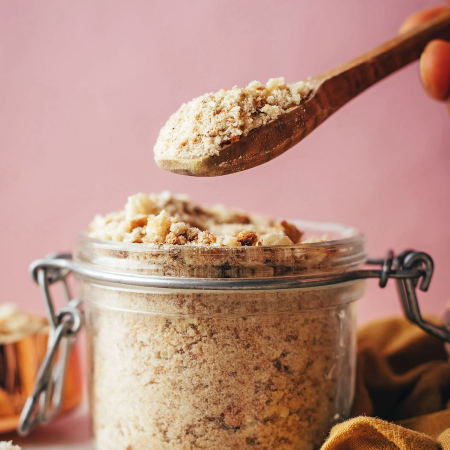Spoonful of homemade breadcrumbs over a jar