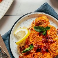Plate of our Cashew-Crusted Cauliflower Steak recipe with the title overlaid in text