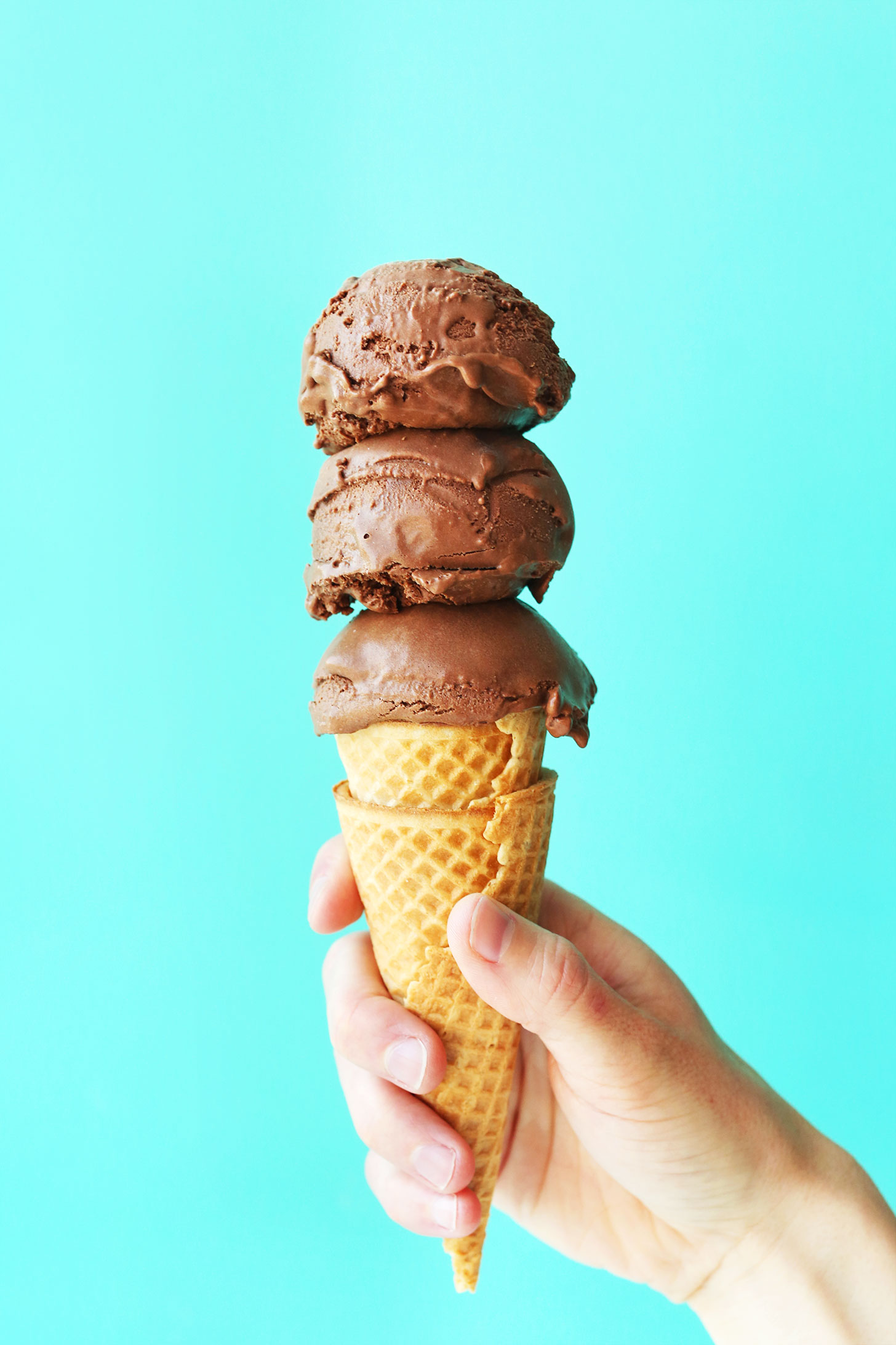 Ice cream cone topped with scoops of vegan chocolate ice cream for our round-up of ice cream recipes